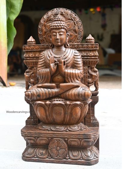 Another view of the 24-inch wax brown Buddha, showing its full form and the detailed throne it sits upon.