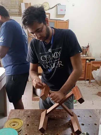 Tejus and Nihal, friends since 5th grade, decided to take on a woodworking workshop together. Here they are, sanding and assembling their planter stands.