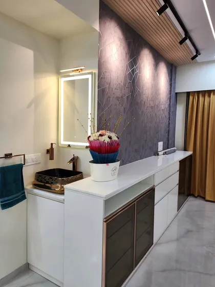 A detailed view of the dining area wash basin, featuring a backlit mirror and a designer black and gold sink. The setup is both functional and a decorative statement.