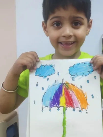 This colorful umbrella in the rain is a perfect example of imaginative drawing. The student has done a wonderful job blending colors to create a rainbow effect.