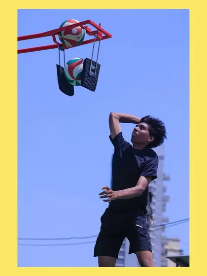 A player focuses on the point of contact during a spike drill. Our structured drills isolate specific parts of a skill to ensure proper technique is learned.