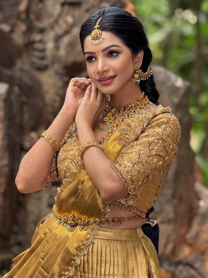 A candid moment from the shoot, showcasing the intricate jewelry and the soft, elegant makeup.