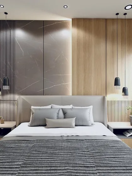 Discover the perfect blend of style and comfort. This bedroom design uses a mix of fluted wood panels and marble-textured walls, with elegant pendant lights flanking the bed for a modern, hotel-like feel.