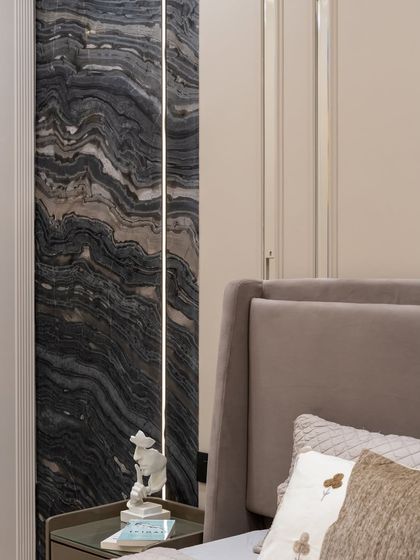 Moody, modern, and magnificently minimal. This bedroom pairs the timeless drama of bookmatched marble with soft satin finishes and calming neutrals. A study in contrast, where raw natural textures meet clean contemporary lines.