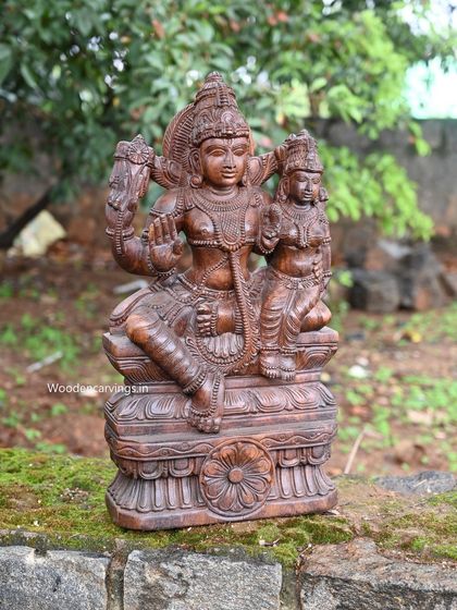 A 24-inch sculpture of Lord Vishnu seated with his consort Maha Lakshmi, a beautiful representation of divine harmony.