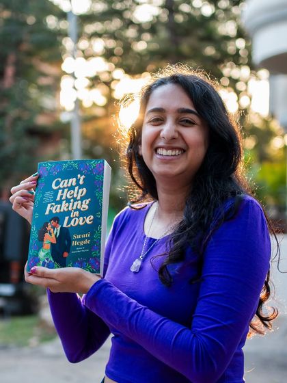 A huge smile for my second book baby, "Can't Help Faking in Love." It's a story about a woman with Bollywood roots who hires a barista as her fake boyfriend.