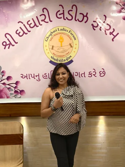 A confident pose with the mic at a ladies' forum event. My one-shoulder top and professional demeanor are perfect for such gatherings.