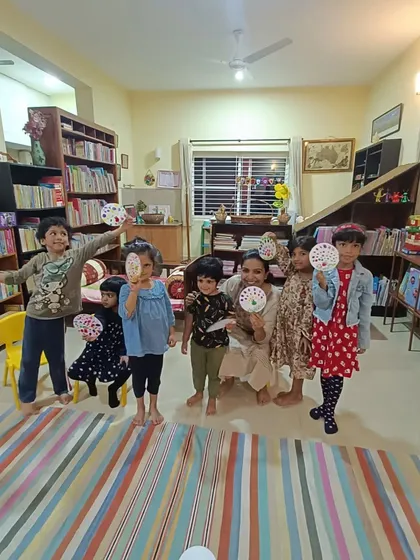A duplicate of the group photo with their dot paintings.