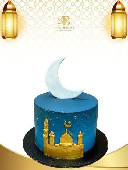 An elegant and modern cake for Eid celebrations. The deep blue cake depicts a golden mosque silhouette against a starry night sky, topped with a white crescent moon.