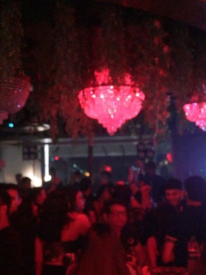 The beautiful chandeliers at Mitron, Thane, glowing red above a packed dancefloor.