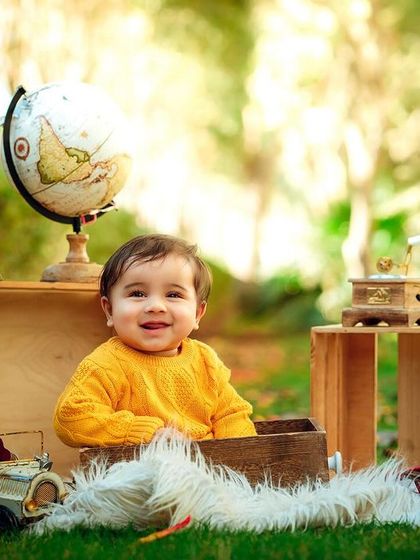 A happy traveler. The bright yellow sweater and warm sunlight make for a cheerful and vibrant outdoor portrait.