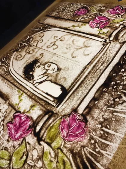 A work in progress for a beautiful song, this piece captures a romantic moment. The use of coloured sand for the flowers adds a touch of softness and beauty.