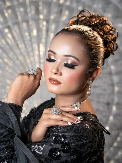 A stunning black-tie or reception look created by one of my talented students. The sharp winged liner, glossy lips, and elegant updo come together for a look of pure sophistication. This is portfolio-worthy work.