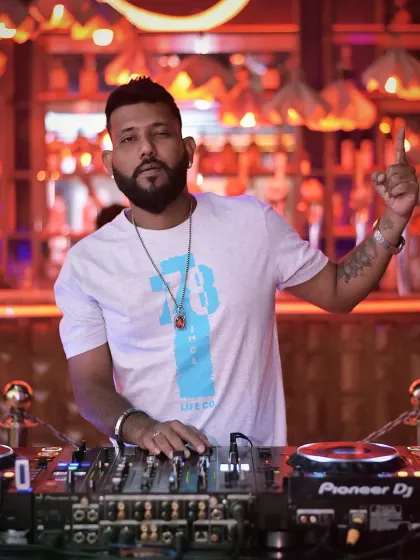 Men at work. Focused on the mix, with the bar lights creating the perfect backdrop for a great night.