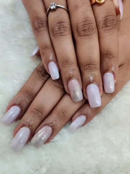 Nude nails for the win, always. This set has a soft, shimmery nude base with a silver glitter accent nail.