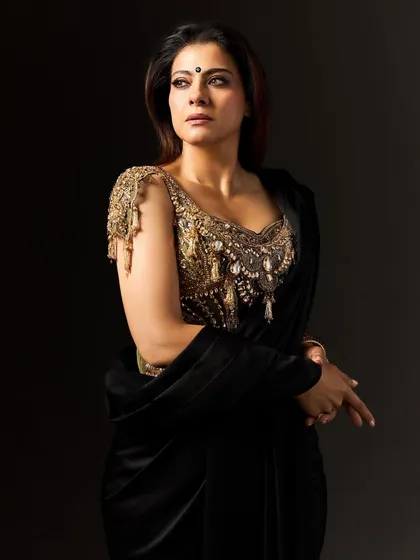 The elegant drape of the saree and the detailed craftsmanship of the blouse are visible in this full-length shot. Every element was considered to channel the fearless spirit of the character, making the costume an extension of her power.