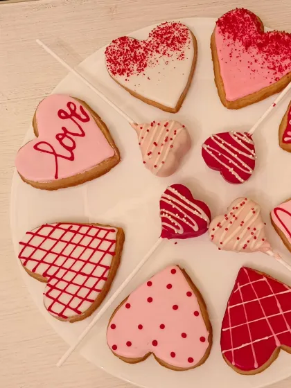 My Valentine's collection also includes these beautifully decorated heart-shaped cookies and cake pops. They come in various pink, red, and white designs, perfect for a sweet gift platter.