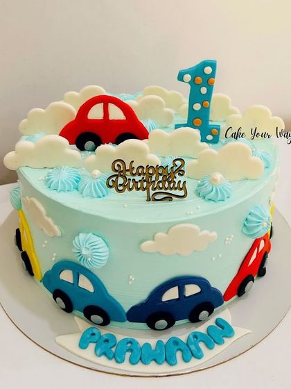 Zooming into one with this adorable car-themed cake, featuring fluffy clouds and colorful fondant cars.
