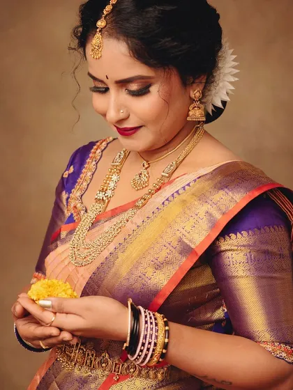 A closer look at the details that make an outfit special. Here, I focused on the rich texture of the saree, the intricate gold jewelry, and the quiet, happy moment of holding festive flowers.