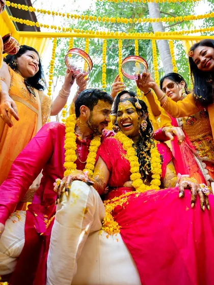 The couple being showered with blessings and haldi by their family members.