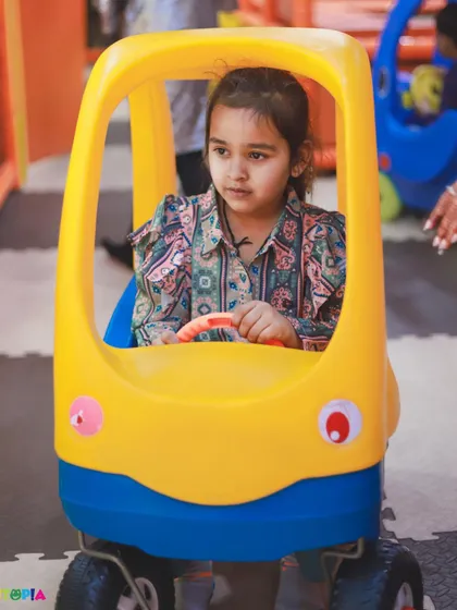 Beep beep! A young guest takes a ride in one of our fun toy cars during a Peppa Pig themed birthday party.