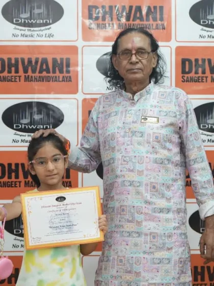 A senior guru blesses a young student as he presents her with an award.