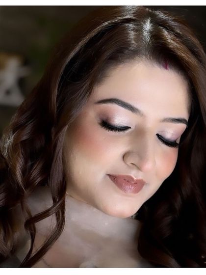 A close-up of a soft and romantic makeup look. The focus is on the blended eyeshadow and the dewy, glowing skin.
