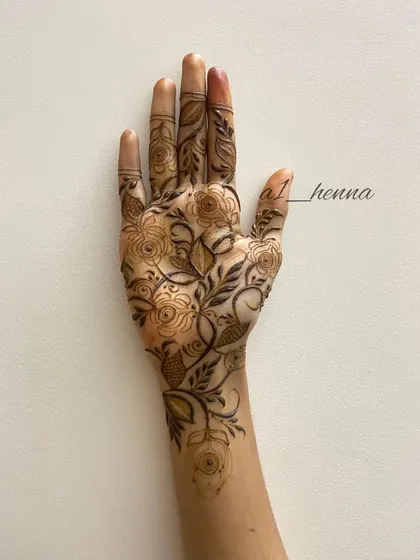 A delicate floral vine design, shown here with the fresh henna paste. This is a beautiful and popular style for parties and casual events.