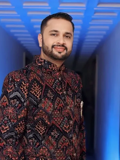 Here is an example of my work on a member of the groom's family. The goal was a polished look that matched the elegance of his patterned sherwani, focusing on a matte finish and defined features for a sophisticated appearance.