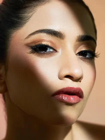 A dramatic look created with light and shadow. The graphic liner and glossy lip create a bold statement that is both modern and powerful.
