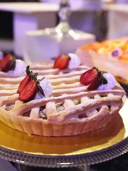 A classic strawberry lattice pie, showcasing our pastry team's skill in traditional baking.