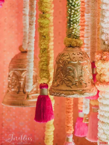 A close-up of the hanging brass bells and colorful tassels used in the Mata ki Chowki decor, adding a traditional and auditory element to the spiritual ambiance.