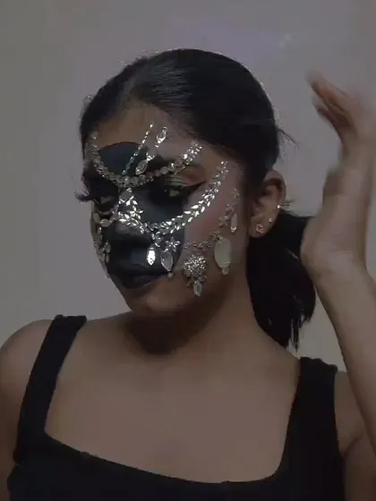 A candid shot of the rhinestone mask look, showing how it moves and catches the light.