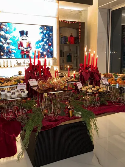 The complete Christmas appetizer and dessert table, beautifully lit and decorated, ready for a night of celebration.