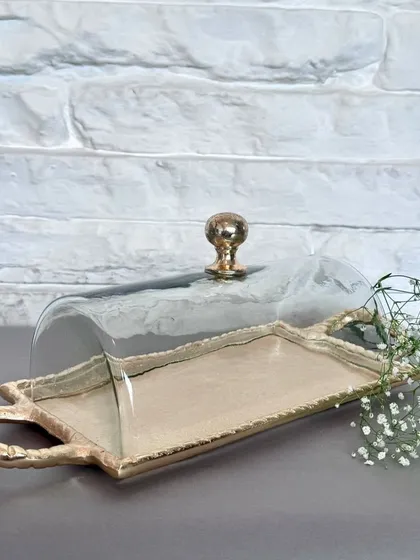 Our rectangular serving tray with a glass cloche, featuring textured gold handles. This elegant piece is perfect for serving pastries or cheese, keeping them fresh while adding a touch of sophistication to your spread.