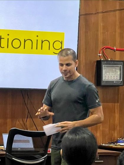 A candid shot during a presentation. My style is direct and information-packed, designed to give coaches tools they can use the very next day.