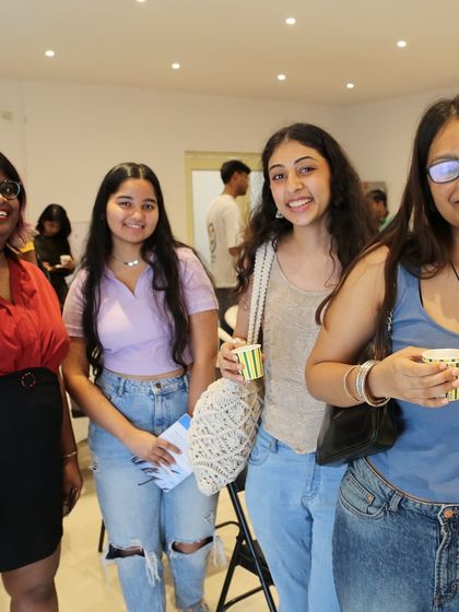 A group of friends enjoying the 'Chai & Poetry' event, a perfect place for students to socialize.