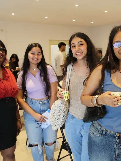 A group of friends enjoying the 'Chai & Poetry' event, a perfect place for students to socialize.