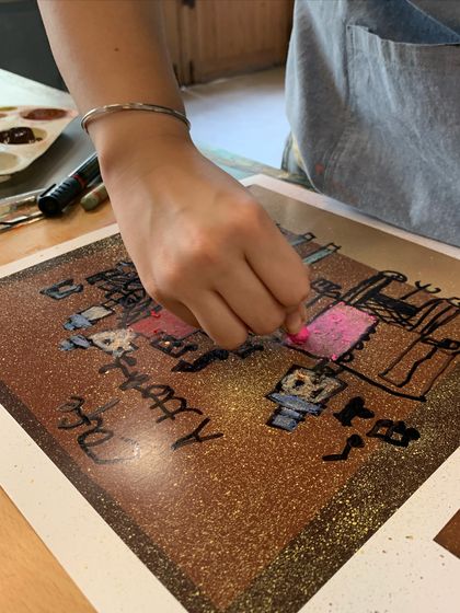 Adding a pop of pink to a drawing, this student is experimenting with color choices.