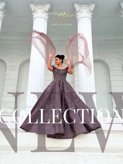 A dramatic shot of a model in a mauve ball gown with flowing cape sleeves. This is a true statement piece for any grand event.