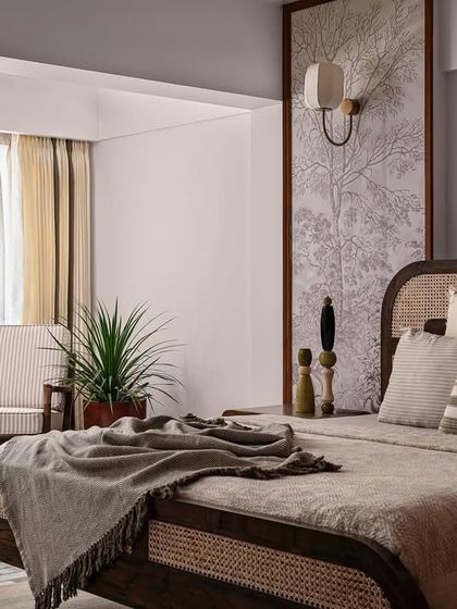 Another view of the bedroom, showing the dark wood and cane bed, complemented by Channapatna lacquered wood decor. The design is a nod to tropical modernism and Sri Lankan aesthetics.