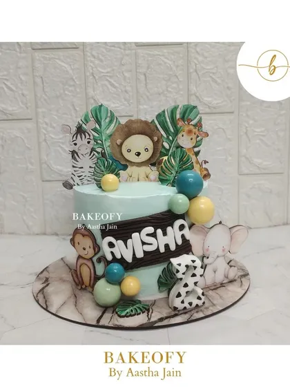 This is my current favorite: the cutest jungle theme cake. It's decorated with adorable animal toppers like a lion, zebra, and elephant, surrounded by tropical leaves.