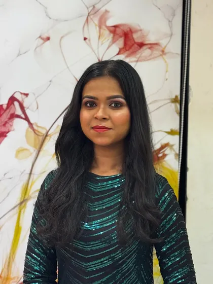 A direct portrait showing the final party makeup. The look is balanced, with well-defined eyes and a neutral lip color that enhances her natural beauty.