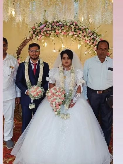 Rachel and her partner on their wedding day. The grandeur of her voluminous ball gown makes for a truly memorable and picture-perfect moment.