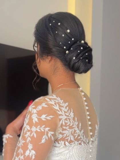 A side view of the pearl bun, showing its elegance and how it complements the delicate details of the wedding gown.