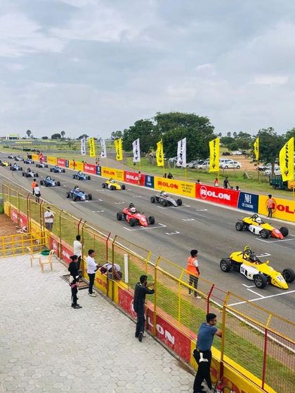 A high-angle view of the starting grid at the Kari Motor Speedway, showing the scale of a Formula LGB championship race.