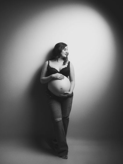 In the simplicity of black and white, beauty shines brightest. This stunning maternity shot in jeans and a bralette embodies vulnerability, strength, and radiant love.