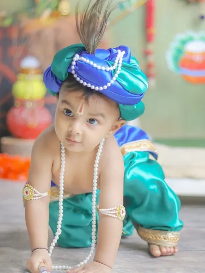 A close-up of this little miracle in his divine form. The details, from the tilak to the peacock feather, are all part of the magic.