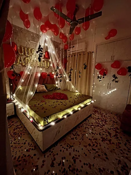 Another perspective of the 'Just Married' room decor, highlighting the placement of balloons on the ceiling and the way the fairy lights illuminate the entire space.