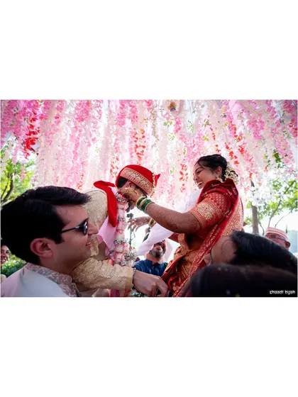 The 'varmala' or garland exchange, often a playful moment as friends lift the bride and groom.